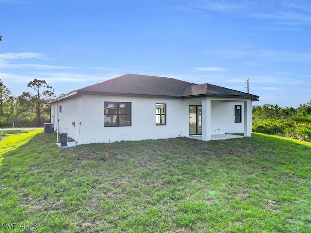 2616 42nd St W, Lehigh Acres, FL 33971 - rear view of property featuring stucco siding and a lawn