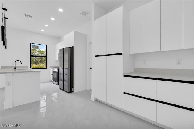 2616 42nd St W, Lehigh Acres, FL 33971 - kitchen with appliances with stainless steel finishes, recessed lighting, modern cabinets, and white cabinets