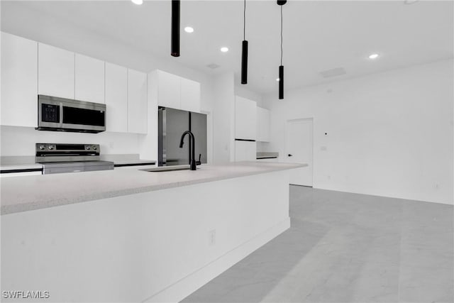 2616 42nd St W, Lehigh Acres, FL 33971 - kitchen featuring appliances with stainless steel finishes, white cabinets, modern cabinets, pendant lighting, and recessed lighting