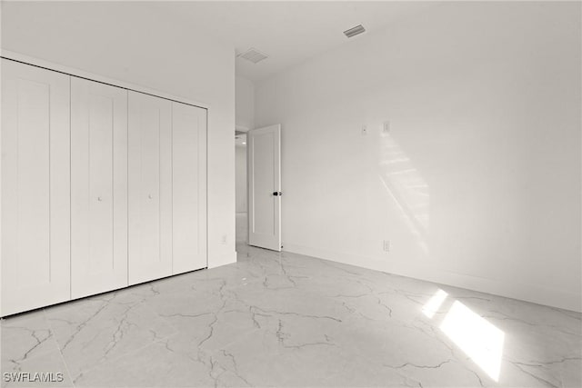 2616 42nd St W, Lehigh Acres, FL 33971 - unfurnished bedroom featuring light marble finish flooring and a closet