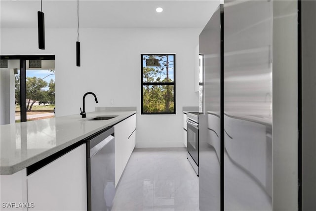 2616 42nd St W, Lehigh Acres, FL 33971 - kitchen featuring modern cabinets, stainless steel appliances, white cabinetry, light stone counters, and recessed lighting