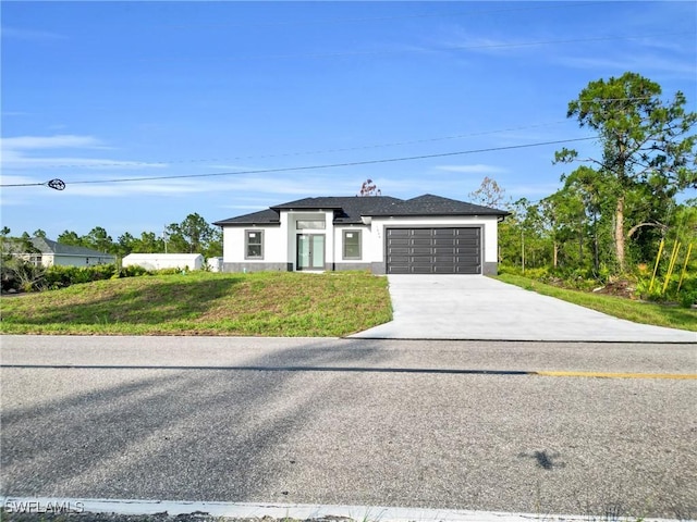 2616 42nd St W, Lehigh Acres, FL 33971 - view of front of property with a garage, driveway, and stucco siding