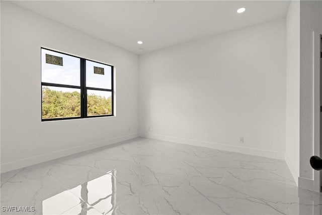 2616 42nd St W, Lehigh Acres, FL 33971 - empty room with marble tiled floors and recessed lighting