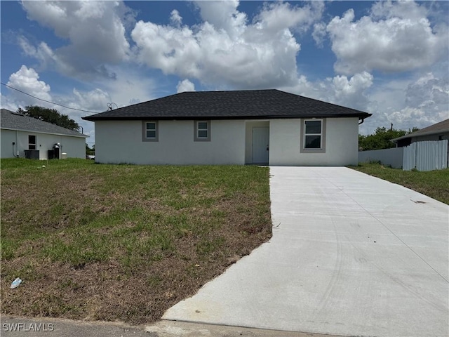 2902 27th St SW, Lehigh Acres, FL 33976 - single story home with driveway, stucco siding, and a front yard