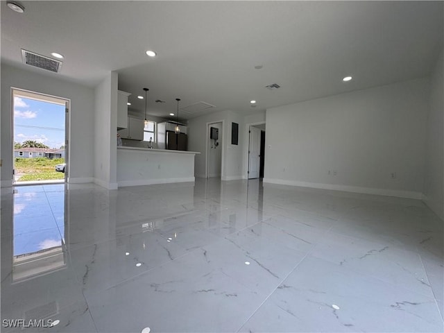 2902 27th St SW, Lehigh Acres, FL 33976 - unfurnished living room featuring recessed lighting and light marble finish flooring