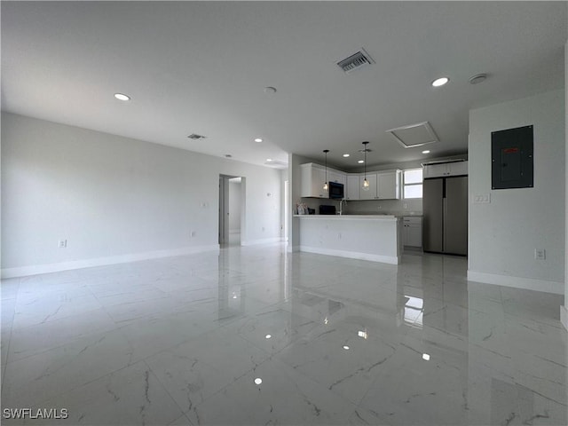 2902 27th St SW, Lehigh Acres, FL 33976 - unfurnished living room with light marble finish floors, electric panel, and recessed lighting