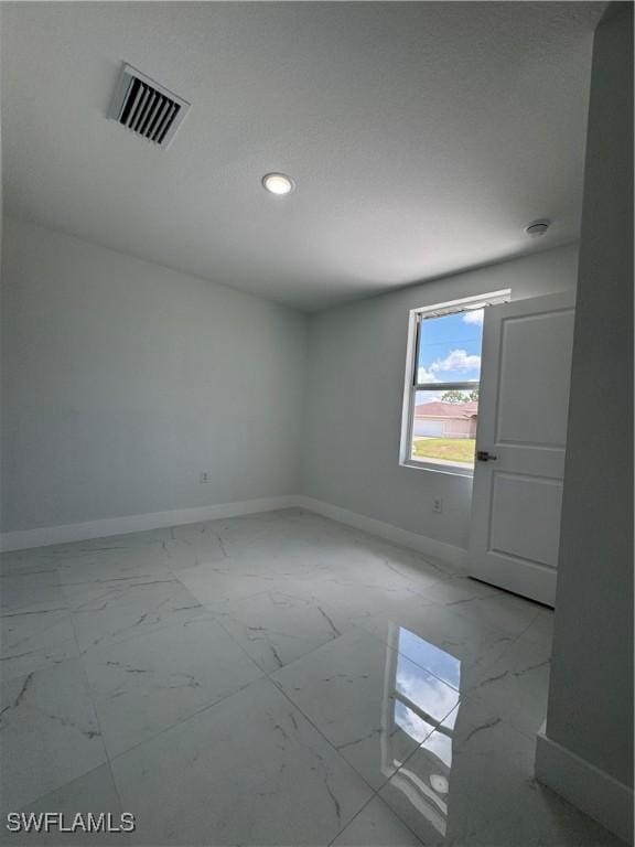 2902 27th St SW, Lehigh Acres, FL 33976 - spare room with light marble finish floors and recessed lighting