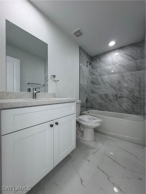 2902 27th St SW, Lehigh Acres, FL 33976 - full bathroom featuring vanity, shower / bathtub combination, marble finish flooring, and recessed lighting