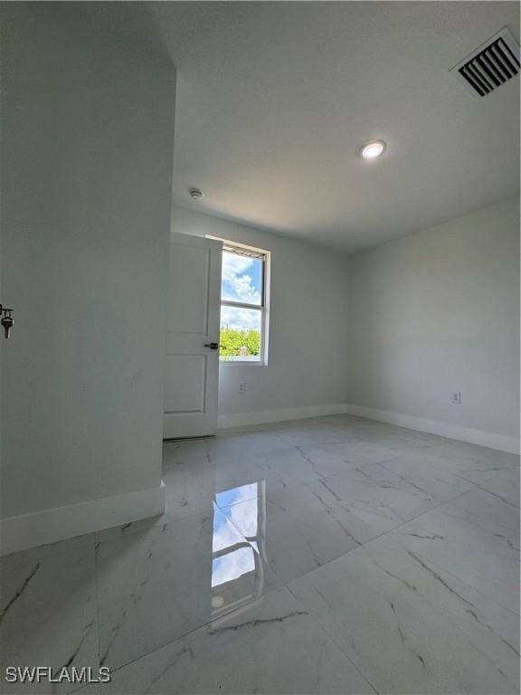 2902 27th St SW, Lehigh Acres, FL 33976 - empty room featuring light marble finish floors and recessed lighting