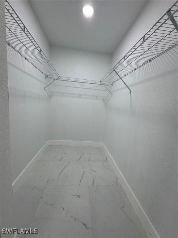 2902 27th St SW, Lehigh Acres, FL 33976 - walk in closet featuring marble finish flooring