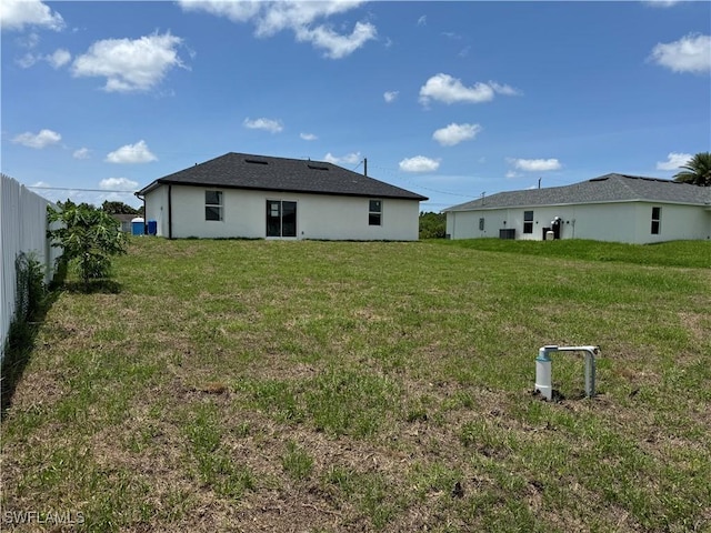 2902 27th St SW, Lehigh Acres, FL 33976 - back of house with a lawn