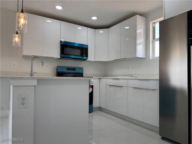 2902 27th St SW, Lehigh Acres, FL 33976 - kitchen with appliances with stainless steel finishes, light marble finish floors, white cabinets, modern cabinets, and recessed lighting