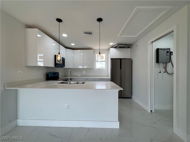 2902 27th St SW, Lehigh Acres, FL 33976 - kitchen featuring appliances with stainless steel finishes, light marble finish flooring, a peninsula, light countertops, and recessed lighting