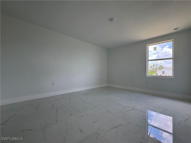 2902 27th St SW, Lehigh Acres, FL 33976 - spare room featuring light marble finish floors and baseboards