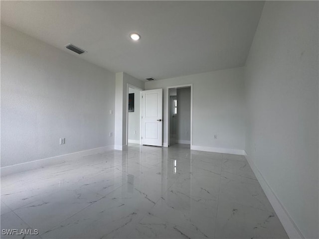 2902 27th St SW, Lehigh Acres, FL 33976 - empty room featuring marble look tiles and recessed lighting