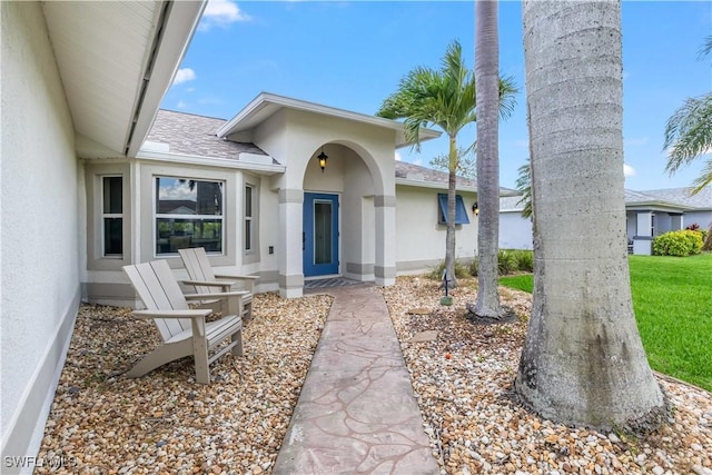 22 NW 14th Ave, Cape Coral, FL 33993 - property entrance featuring stucco siding and a shingled roof