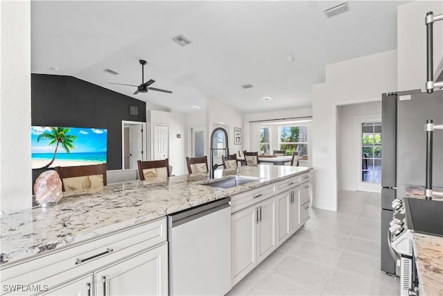 22 NW 14th Ave, Cape Coral, FL 33993 - kitchen with dishwashing machine, a ceiling fan, vaulted ceiling, light stone countertops, and light tile patterned flooring