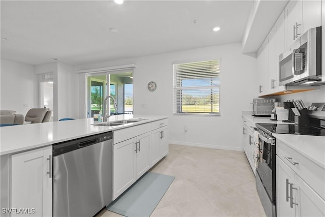 14818 Birchwood Ct Unit 6412, Punta Gorda, FL 33955 - kitchen featuring appliances with stainless steel finishes, light countertops, white cabinetry, recessed lighting, and open floor plan