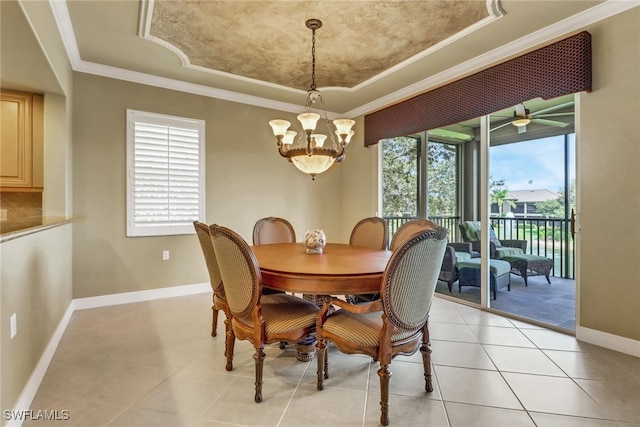 713 Regency Reserve Cir Unit 5903, Naples, FL 34119 - dining space featuring a tray ceiling, healthy amount of natural light, a chandelier, light tile patterned floors, and crown molding
