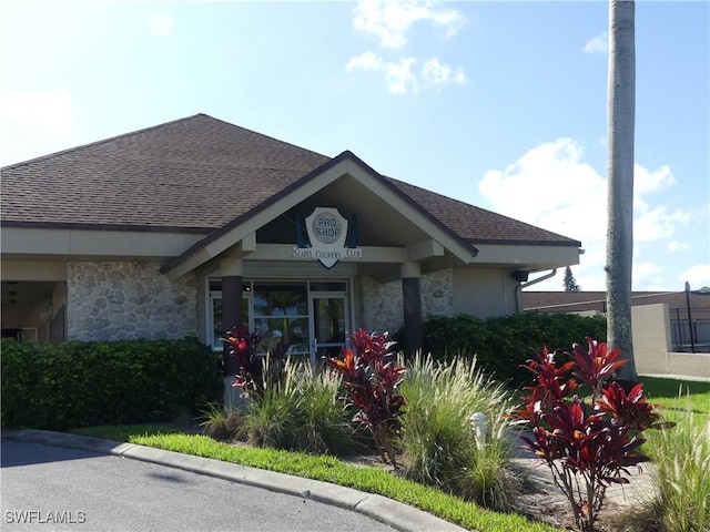 79 Glades Blvd Unit 1623, Naples, FL 34112 - view of front of house featuring roof with shingles and stone siding