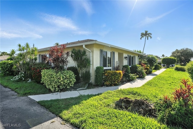79 Glades Blvd Unit 1623, Naples, FL 34112 - view of side of home featuring stucco siding