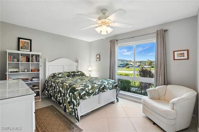 79 Glades Blvd Unit 1623, Naples, FL 34112 - bedroom featuring light tile patterned flooring, a ceiling fan, and a textured ceiling