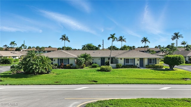79 Glades Blvd Unit 1623, Naples, FL 34112 - ranch-style home featuring a front lawn, a residential view, and stucco siding