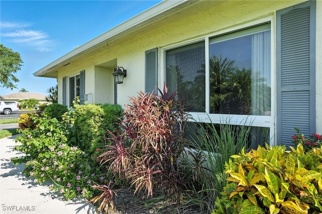 79 Glades Blvd Unit 1623, Naples, FL 34112 - view of property exterior with stucco siding