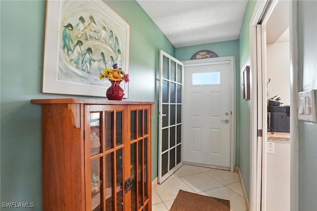 79 Glades Blvd Unit 1623, Naples, FL 34112 - foyer entrance with light tile patterned floors and a textured ceiling
