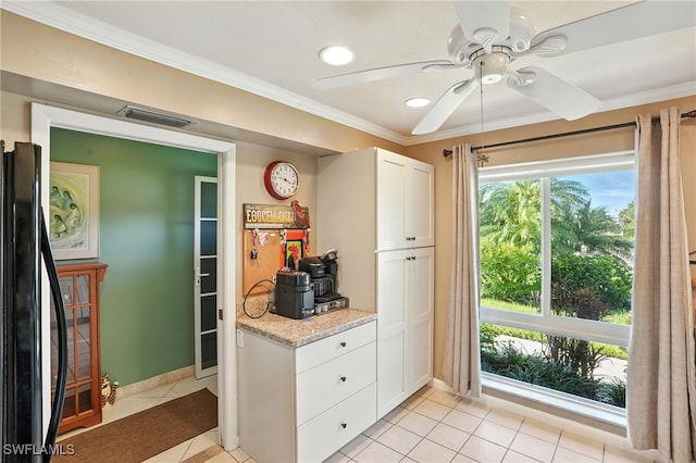 79 Glades Blvd Unit 1623, Naples, FL 34112 - kitchen with black refrigerator, ornamental molding, white cabinetry, light tile patterned floors, and a ceiling fan