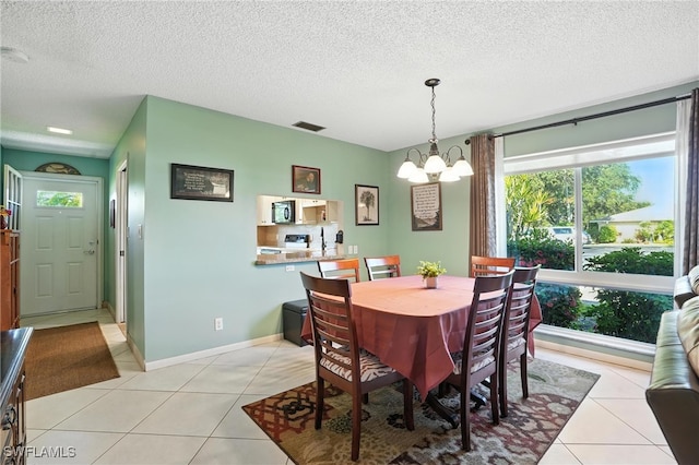 79 Glades Blvd Unit 1623, Naples, FL 34112 - dining area featuring a chandelier, light tile patterned floors, and a textured ceiling