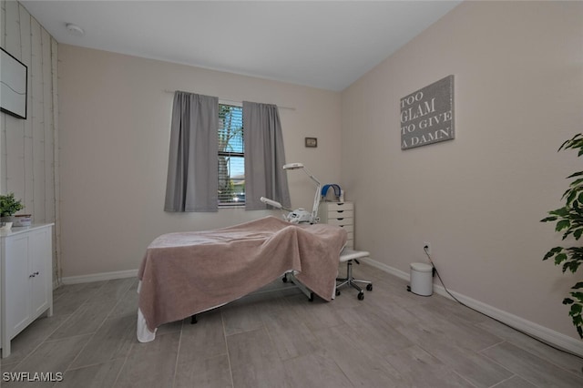 17573 Ashcomb Way, Estero, FL 33928 - bedroom with light wood-style floors and wooden walls