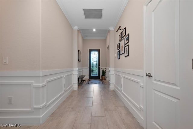 17573 Ashcomb Way, Estero, FL 33928 - hallway featuring ornamental molding, a wainscoted wall, and a decorative wall