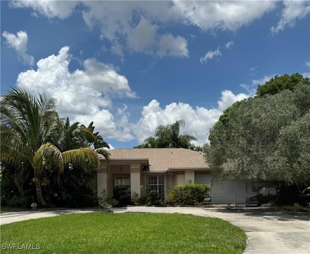 9973 Boca Ave N, Naples, FL 34109 - view of front of property with stucco siding and a front lawn