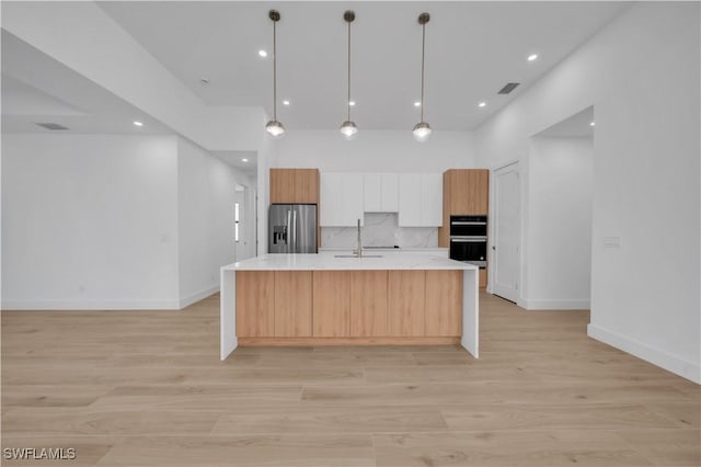 1502 SW 17th Ave, Cape Coral, FL 33991 - kitchen with stainless steel appliances, light countertops, light wood-type flooring, modern cabinets, and recessed lighting