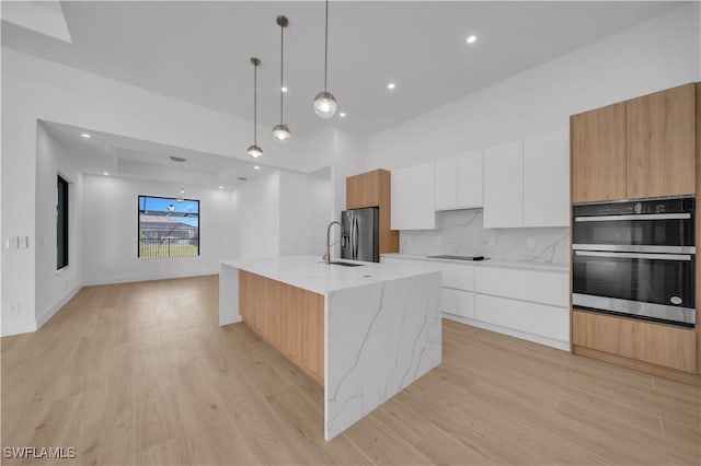 1502 SW 17th Ave, Cape Coral, FL 33991 - kitchen featuring modern cabinets, stainless steel appliances, light wood-style flooring, white cabinetry, and recessed lighting
