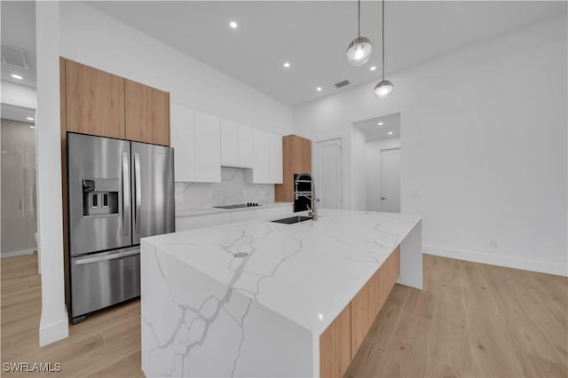1502 SW 17th Ave, Cape Coral, FL 33991 - kitchen featuring stainless steel fridge, modern cabinets, white cabinetry, light wood-type flooring, and recessed lighting