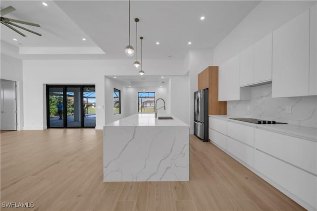 1502 SW 17th Ave, Cape Coral, FL 33991 - kitchen with modern cabinets, freestanding refrigerator, black electric stovetop, and recessed lighting