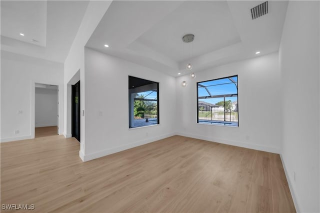 1502 SW 17th Ave, Cape Coral, FL 33991 - empty room with a raised ceiling, light wood-type flooring, and recessed lighting