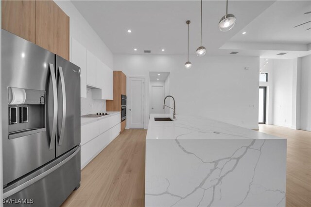 1502 SW 17th Ave, Cape Coral, FL 33991 - kitchen with stainless steel appliances, modern cabinets, light wood-type flooring, white cabinets, and recessed lighting
