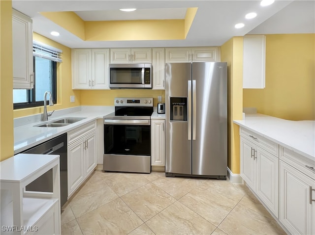 4770 Estero Blvd Unit 203, Fort Myers Beach, FL 33931 - kitchen with stainless steel appliances, a raised ceiling, light countertops, and recessed lighting