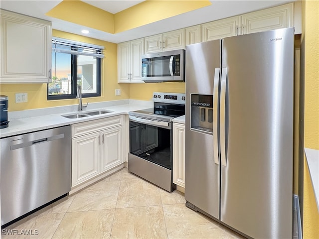 4770 Estero Blvd Unit 203, Fort Myers Beach, FL 33931 - kitchen featuring stainless steel appliances, light countertops, cream cabinets, light tile patterned floors, and recessed lighting