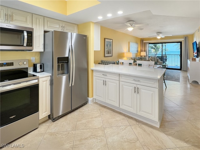 4770 Estero Blvd Unit 203, Fort Myers Beach, FL 33931 - kitchen featuring stainless steel appliances, a peninsula, light countertops, a ceiling fan, and recessed lighting