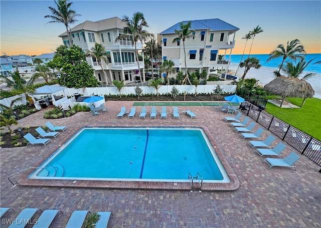 4770 Estero Blvd Unit 203, Fort Myers Beach, FL 33931 - pool at dusk with a community pool, a water view, and a patio