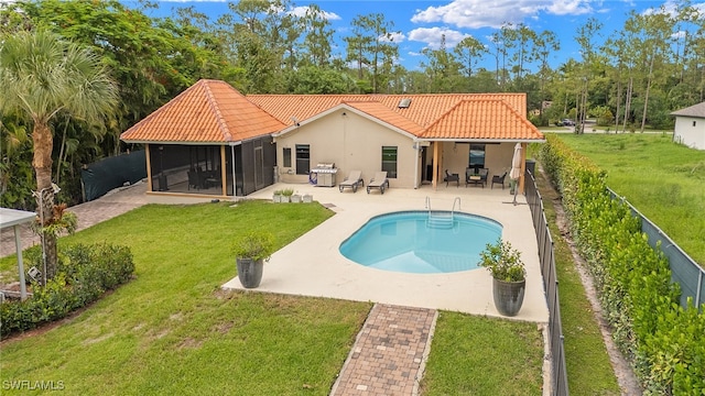 3270 14th Ave NE, Naples, FL 34120 - rear view of property with a tile roof, a sunroom, a patio area, stucco siding, and a fenced backyard