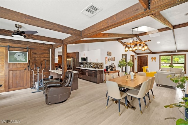 3270 14th Ave NE, Naples, FL 34120 - dining space featuring beamed ceiling, a barn door, a chandelier, light wood-type flooring, and ceiling fan