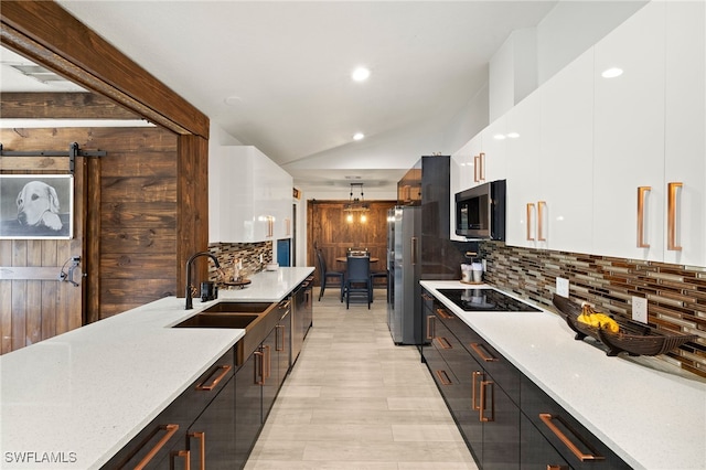 3270 14th Ave NE, Naples, FL 34120 - kitchen with appliances with stainless steel finishes, white cabinets, modern cabinets, decorative backsplash, and light wood-type flooring