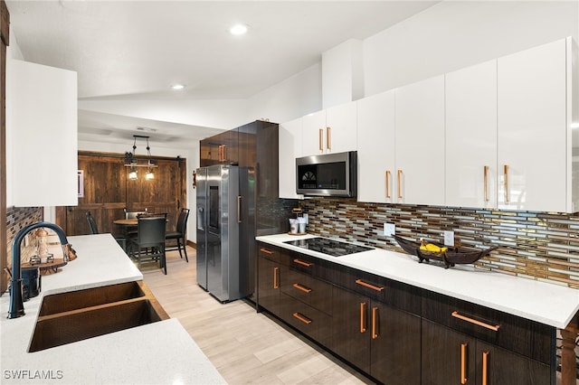 3270 14th Ave NE, Naples, FL 34120 - kitchen with stainless steel appliances, light countertops, white cabinetry, light wood finished floors, and recessed lighting