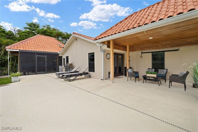 3270 14th Ave NE, Naples, FL 34120 - rear view of house featuring a patio, a sunroom, a tile roof, an outdoor living space, and stucco siding
