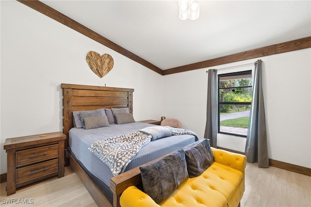 3270 14th Ave NE, Naples, FL 34120 - bedroom with light wood-style floors and vaulted ceiling